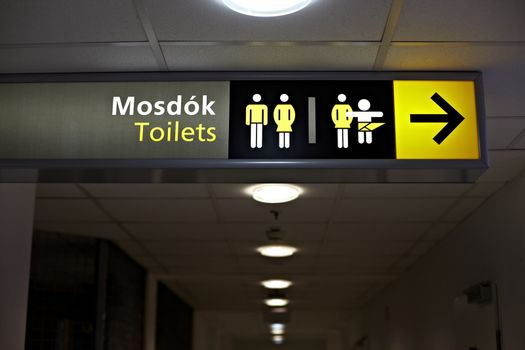 Toilets sign in a building corridor