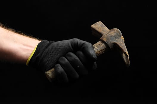 Hammer and a Hand on a Black Background