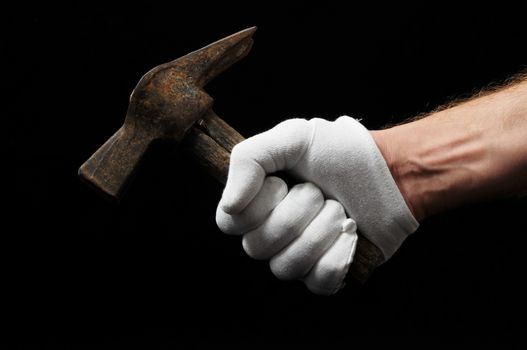 Hammer and a Hand on a Black Background