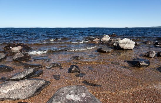 Large gray rocks on the shore of Lake Kolvitsa. Murmansk region. Russia