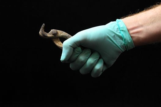 Cutter Pliers and a Hand on a Black Background