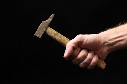 Hammer and a Hand on a Black Background