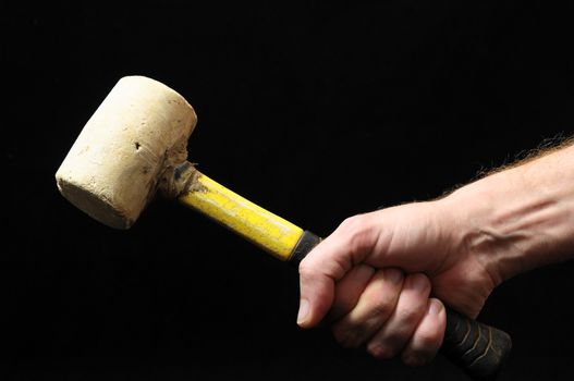 Hammer and a Hand on a Black Background