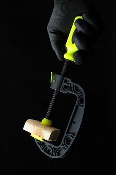 Pliers and a Hand on a Black Background