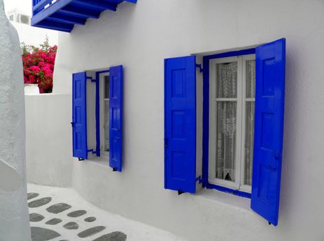 Greek islands traditionalarchitecture with blue windows and passageways