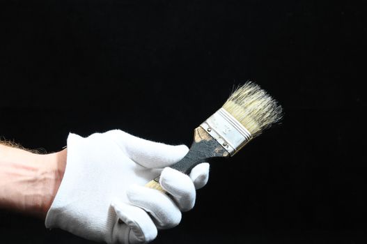 Brush  and a Hand on a Black Background