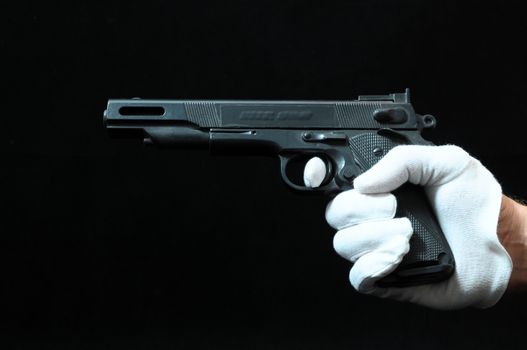 Gun and a Hand on a Black Background