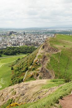 Arthur's Seat is the main peak of the group of hills which form most of Holyrood Park. It is situated in the centre of the city of Edinburgh, about a mile to the east of Edinburgh Castle. The hill rises above the city to a height of 250.5 m (822 ft), provides excellent panoramic views of the city, is relatively easy to climb, and is popular for hillwalking.