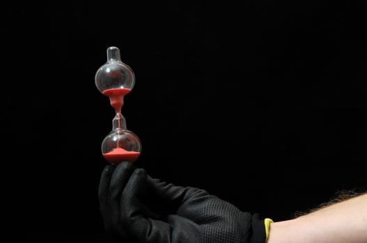 Clock And an Hand on a Black Background