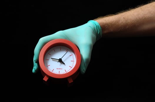 Clock And an Hand on a Black Background