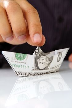 origami paper sailboat, money concept
