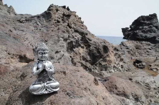 One Ancient Gray Buddha Statue Near The Ocean