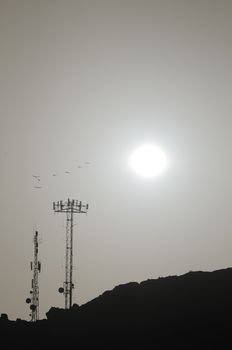 Some Silhouetted Antennas on the top of a Hill