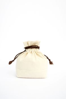 Canvas bag full of spices on a white background