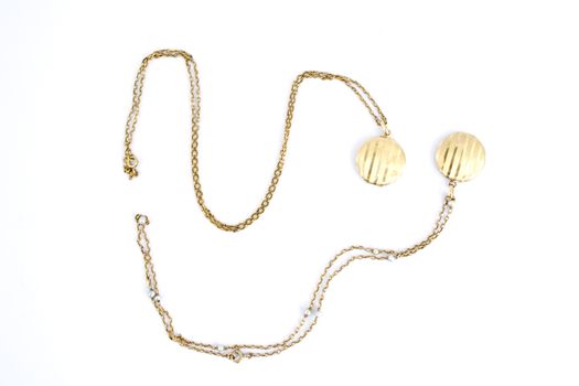 Pair of gold lockets on a white background