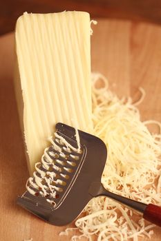 Grated cheese with grater, close up
