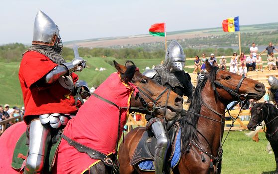 KHOTYN - MAY 10: Knights on horseback  fighting during Festival Medieval Khotyn on May 10, 2013, Ukraine