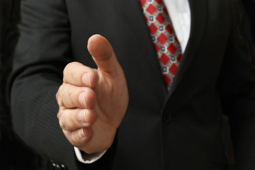 closeup of businessman's hand outstretched for a handshake