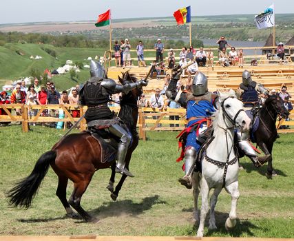 KHOTYN - MAY 10: Knights on horseback  fighting during Festival Medieval Khotyn on May 10, Ukraine