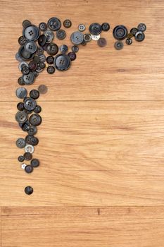 Border of buttons on a wooden background