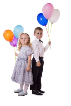 Sweet boy and girl with colorful balloons over white