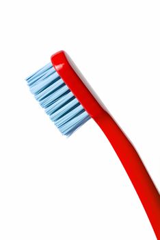 Colored toothbrush diagonally isolated on white background