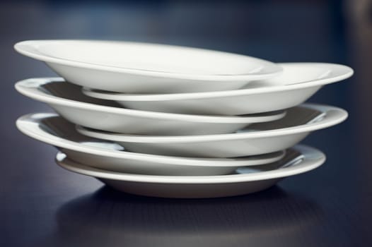 A stack of white plates on a table