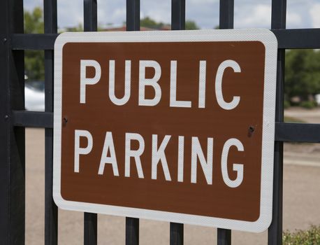 Brown public parking sign with white letters