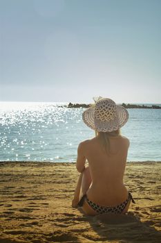 girl looks at the sea in summer