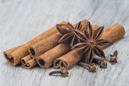 Cinnamon sticks and star anise on a wooden background