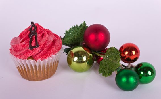 Christmas tree ornament and cupcake with candle