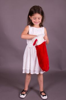 Little girl with Christmas stocking