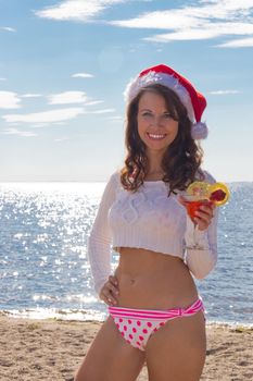 Girl with cocktail on the beach.  Christmas Vacation