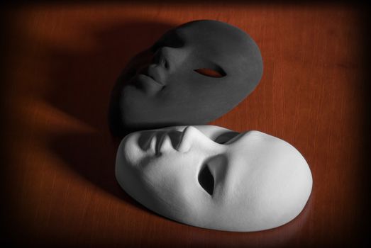 Black and white carnival mask on a wooden background.