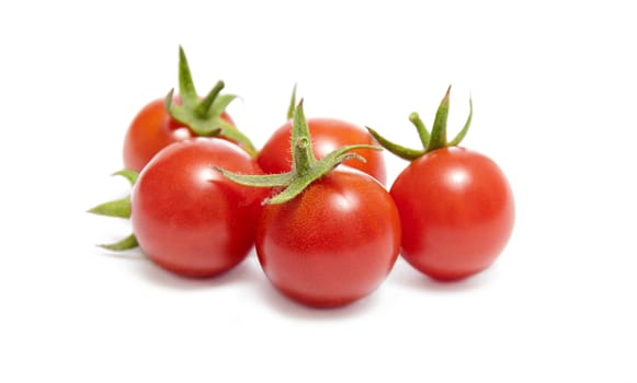 Ripe red cherry tomatoes on white background.