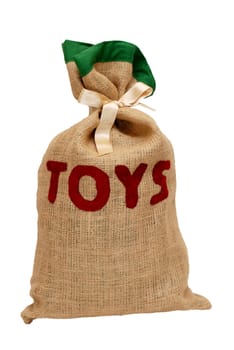 Santa's hessian toy sack full of toys and tied with a satin ribbon, isolated on a white background