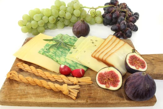 a wooden board with a variety of cheeses