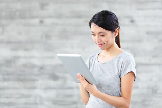 young asian woman using tablet computer