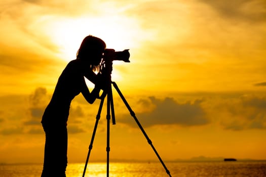 Silhouette photographer at sunset