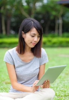 Asian woman looking at computer tablet