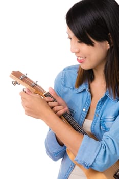 Asian woman tuning ukelele