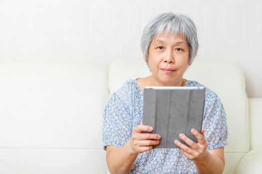 Asian old woman with digital tablet