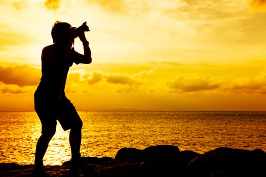 Silhouette of photographer at sunset