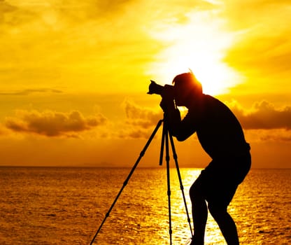 Silhouette photographer at sunset