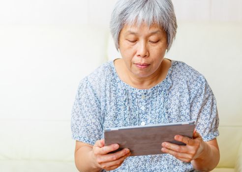 Asian senior woman with digital table