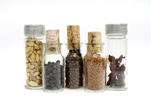 Glass container filled with spices and cork stopper