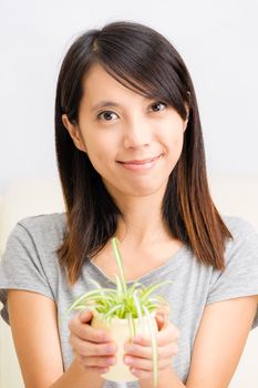 Asian woman with potted plant