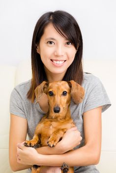 Asian woman and dachshund dog