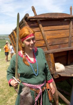 KHOTYN - MAY 10: Unidentified smiling redheaded girl with sword during Festival Medieval Khotyn on May 10, Ukraine