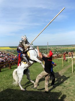 KHOTYN - MAY 10: Knight with lance riding a bucking horse during Festival Medieval Khotyn on May 10, Ukraine